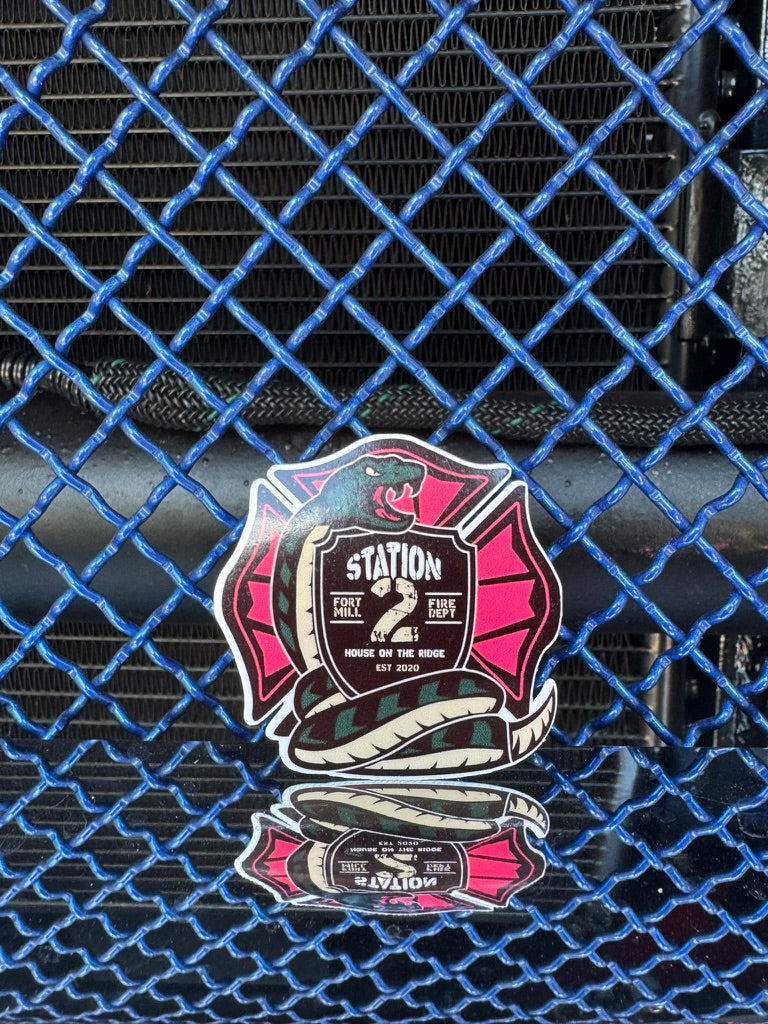 Finished Station 2 sticker on blue and chrome background